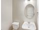 Bathroom featuring white toilet, pedestal sink, and modern mirror at 11267 Central Ct, Broomfield, CO 80021