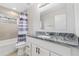 Bathroom with marble countertop, decorative tile, and shower with curtain at 875 E 78Th Ave # 52, Denver, CO 80229