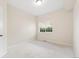 Bedroom with neutral carpet, window, and door access at 875 E 78Th Ave # 52, Denver, CO 80229