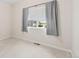 Bedroom with neutral carpet, window with shades, and view to cars parked outside at 875 E 78Th Ave # 52, Denver, CO 80229
