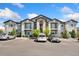 Apartment building featuring multiple balconies and well-maintained parking lot at 875 E 78Th Ave # 52, Denver, CO 80229