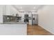 Bright kitchen with stainless steel appliances and countertops overlooking kitchen island at 875 E 78Th Ave # 52, Denver, CO 80229
