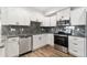 Modern kitchen with white cabinets, stainless steel appliances, and granite countertops and backsplash at 875 E 78Th Ave # 52, Denver, CO 80229