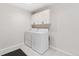 Laundry room featuring white cabinets, tile floor, and modern washer and dryer at 875 E 78Th Ave # 52, Denver, CO 80229