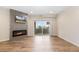 Open living room featuring a modern fireplace with tile surround and a sliding glass door to the balcony at 875 E 78Th Ave # 52, Denver, CO 80229