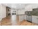 Open concept living room showcasing a fireplace and modern kitchen with stainless steel appliances at 875 E 78Th Ave # 52, Denver, CO 80229