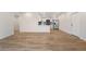 Open concept living space into kitchen with stainless steel appliances and light wood flooring at 875 E 78Th Ave # 52, Denver, CO 80229