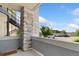 Covered patio with stone accents and view of parking at 875 E 78Th Ave # 52, Denver, CO 80229