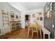 Bright dining area with wood floors and a charming bench at 202 Lower Glenway St, Palmer Lake, CO 80133