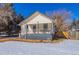 Craftsman home with front porch, snowy yard, and mature trees at 202 Lower Glenway St, Palmer Lake, CO 80133