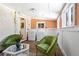 Bright laundry room with two green chairs and a table at 202 Lower Glenway St, Palmer Lake, CO 80133