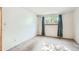 This bedroom features white walls, carpeted flooring, and a window with curtains at 7755 E Quincy Ave # 104A6, Denver, CO 80237