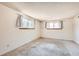 A bright and inviting bedroom features carpeting and two large windows with translucent curtains at 7755 E Quincy Ave # 104A6, Denver, CO 80237