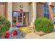 Entrance features a bright pink door, three steps, and adjacent landscaping at 7755 E Quincy Ave # 104A6, Denver, CO 80237