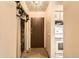 Entryway featuring a brown door, shelf, white oven, and tiled flooring at 7755 E Quincy Ave # 104A6, Denver, CO 80237