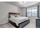 This is a bright bedroom featuring a large window, carpeted floors, and a bed at 1841 S Dunkirk St # 101, Aurora, CO 80017