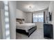 The main bedroom features a large window, dark wood furniture, and carpeted floors at 1841 S Dunkirk St # 101, Aurora, CO 80017