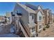 A beautiful shot of the exterior of this two-story condo with stone and siding and a stairway leading to the front door at 1841 S Dunkirk St # 101, Aurora, CO 80017