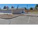 Row of garages with reserved parking spots and neutral paint, set against a backdrop of blue sky on a sunny day at 1841 S Dunkirk St # 101, Aurora, CO 80017