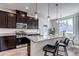 This is a beautiful kitchen that boasts dark cabinets, stainless steel appliances, granite countertops, and a lovely island at 1841 S Dunkirk St # 101, Aurora, CO 80017