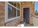 Cozy patio with brick accents offering an intimate outdoor seating area with white metal chairs at 1841 S Dunkirk St # 101, Aurora, CO 80017