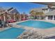 Inviting community swimming pool with lounge chairs and shaded areas for relaxation on a sunny day at 1841 S Dunkirk St # 101, Aurora, CO 80017