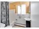 Bathroom with a shower-tub combo, bright lighting, and classic white tile at 1375 N Williams St # 206, Denver, CO 80218