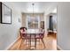 Bright dining room features a modern light fixture, a spacious dining table, and a view to the outside at 1375 N Williams St # 206, Denver, CO 80218