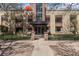 Charming brick exterior of a multi-unit dwelling with decorative metal fence and well-maintained landscaping at 1375 N Williams St # 206, Denver, CO 80218