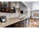 Well-equipped kitchen featuring granite countertops, dark wood cabinets, modern appliances, and ample counter space at 1375 N Williams St # 206, Denver, CO 80218