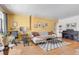 Inviting living room featuring hardwood floors, a sofa, workspace, and piano, perfect for relaxation and productivity at 1375 N Williams St # 206, Denver, CO 80218