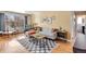 Comfortable living room features a couch, area rug, large window, and an office area, bathed in natural light at 1375 N Williams St # 206, Denver, CO 80218
