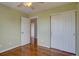 Bright bedroom featuring hardwood floors, a ceiling fan, and a closet with sliding doors at 2253 E 100Th Pl, Thornton, CO 80229