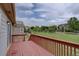 The red painted wooden deck offers great views of the spacious grassy backyard and surrounding neighborhood at 2253 E 100Th Pl, Thornton, CO 80229