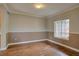 Cozy dining area featuring hardwood floors, wainscoting, and a window providing natural light at 2253 E 100Th Pl, Thornton, CO 80229
