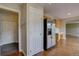 Spacious kitchen with stainless steel refrigerator and hardwood floors at 2253 E 100Th Pl, Thornton, CO 80229