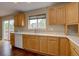 Bright kitchen featuring wooden cabinets, white countertops, and a window above the sink at 2253 E 100Th Pl, Thornton, CO 80229