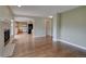 Open-concept living room view into kitchen with fireplace and hardwood floors at 2253 E 100Th Pl, Thornton, CO 80229