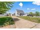 Street view of house featuring manicured lawn, long driveway, inviting curb appeal and a detached garage at 235 S 8Th Ave, Brighton, CO 80601
