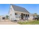 Charming house with white siding, a gray roof, and a well-maintained front yard, perfect for comfortable living at 235 S 8Th Ave, Brighton, CO 80601