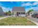 View of charming single-Gathering home with well-maintained front yard, complemented by a classic design and ample parking at 235 S 8Th Ave, Brighton, CO 80601