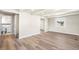 Open-concept living room with wood-look floors, white trim, recessed lighting, and an adjacent bathroom at 235 S 8Th Ave, Brighton, CO 80601