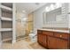 Elegant bathroom featuring a glass shower, marble tile, and custom vanity with marble countertop at 4115 Zenobia St, Denver, CO 80212