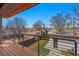 Exterior deck featuring wood-grain deck, black metal railing, and a view of the fenced backyard at 4115 Zenobia St, Denver, CO 80212