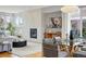 Elegant living room with a stone fireplace, modern lighting, and open dining area for stylish entertaining at 4115 Zenobia St, Denver, CO 80212