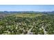 Expansive aerial view showcases the neighborhood's lush green landscape, scenic mountain backdrop, and abundant mature trees at 2775 Crabapple Rd, Golden, CO 80401