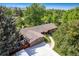 Aerial view of the home and neighborhood shows tree coverage and mountain views at 2775 Crabapple Rd, Golden, CO 80401