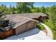 Aerial view of a well-maintained home with a two-car garage, a basketball hoop, and mature trees at 2775 Crabapple Rd, Golden, CO 80401