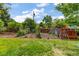 Backyard features a lush garden area, and a charming wooden chicken coop at 2775 Crabapple Rd, Golden, CO 80401