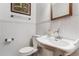 Elegant powder room featuring a white vanity and charming wainscoting at 2775 Crabapple Rd, Golden, CO 80401